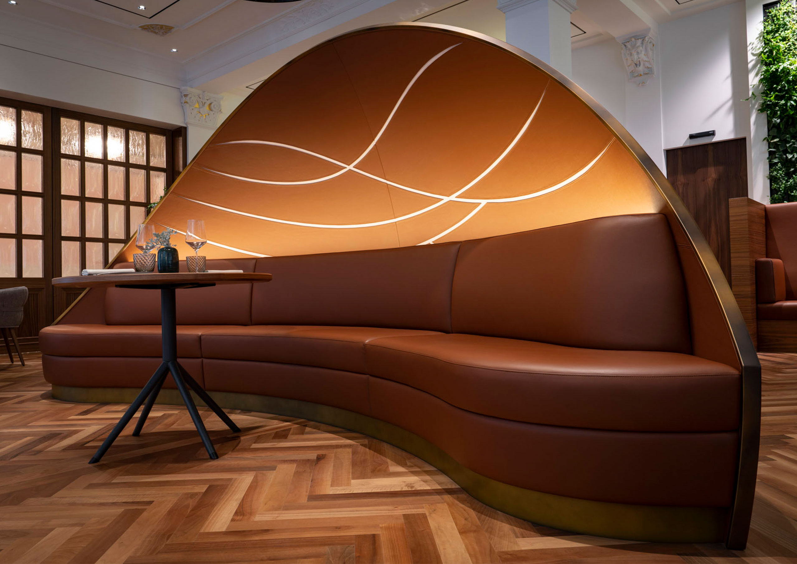 Maßgefertigte Leder-Sitzbank mit beleuchteter Wandverkleidung im Restaurant „Verve by Sven“ im Hotel Quellenhof, gefertigt von F/LIST.